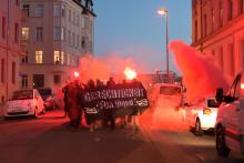 Bild einer Demonstration, Banner mit der Aufschrift Gerechtigkeit für Maja, Rote Pyrotechnik dahinter